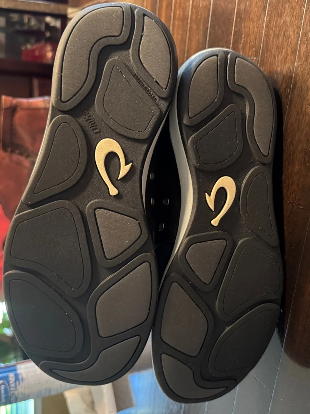 OluKai Moku-pai Men’s Knit Slip-On Sneakers in Black with black leather accent.